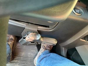 Universal under steering column pistol carrier