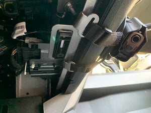 Universal under steering column pistol carrier