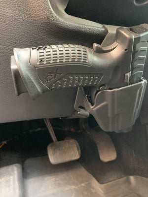 Universal under steering column pistol carrier