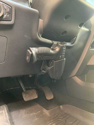 Universal under steering column pistol carrier