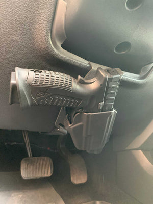 Universal under steering column pistol carrier