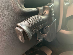 Universal under steering column pistol carrier