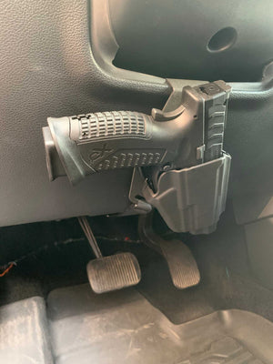 Universal under steering column pistol carrier